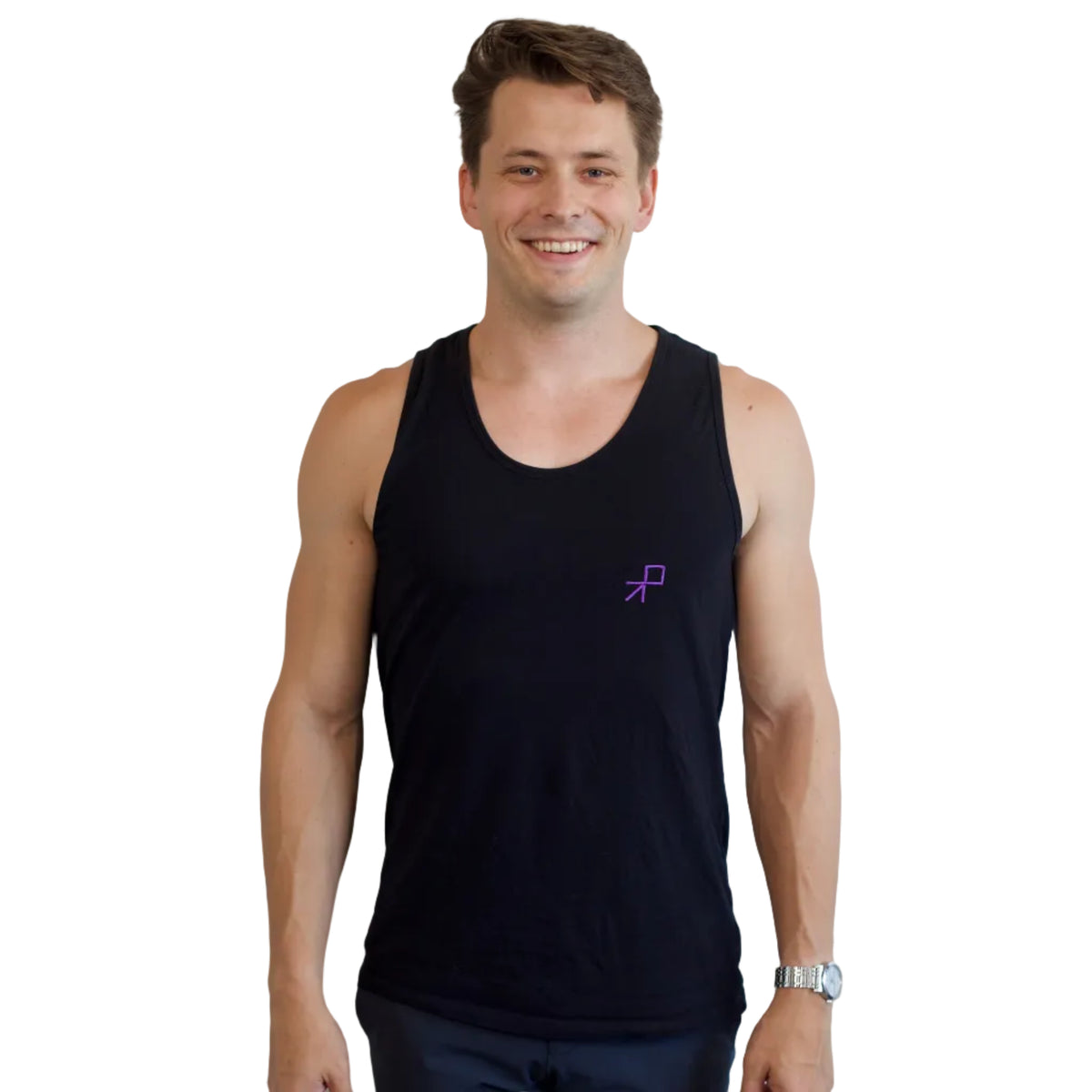 A smiling mdancer wearing a black tank top with a small purple embroidered push logo on the left chest, standing against a plain white wall.