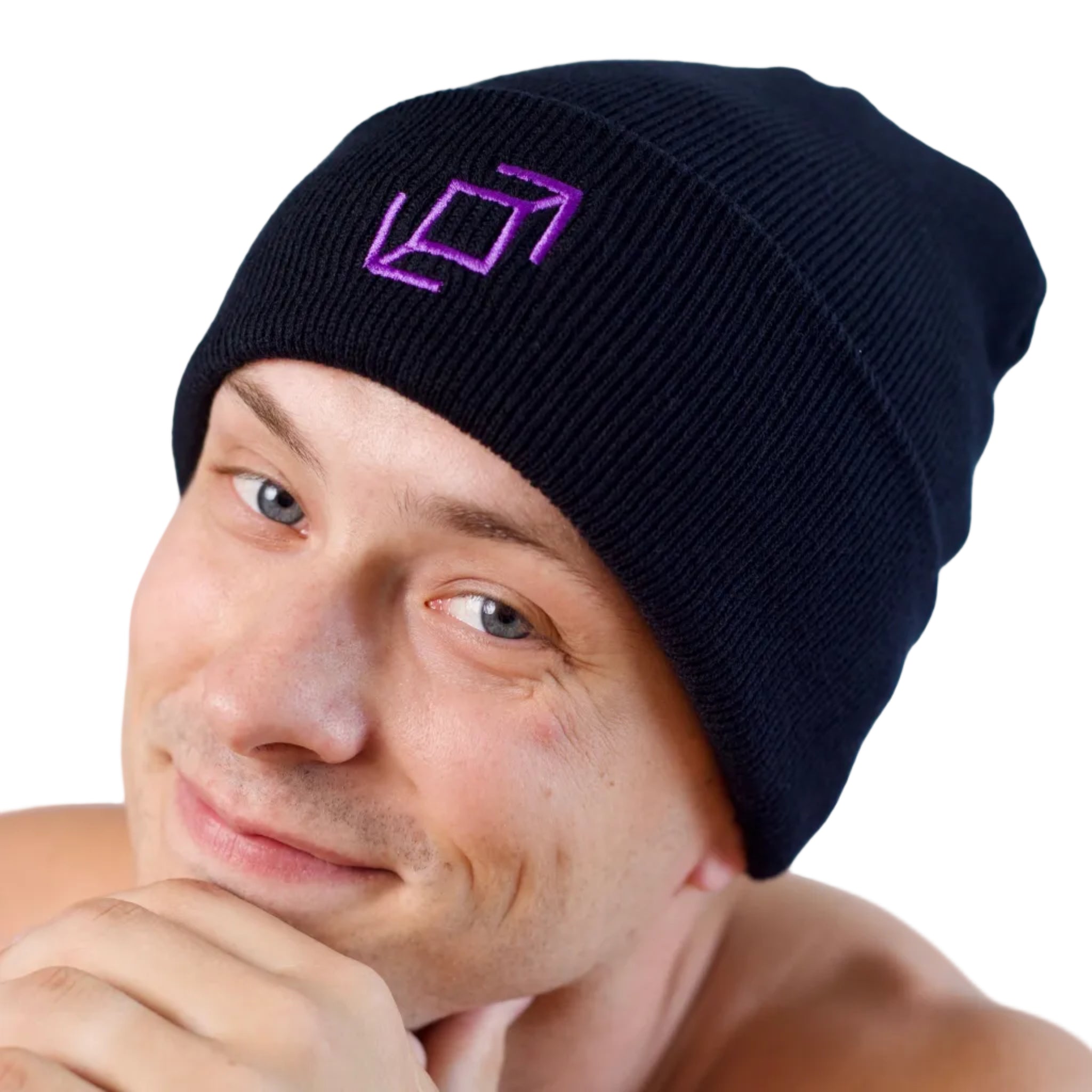 A close-up of a mdancer wearing a black push pass whip ribbed knit beanie with a purple geometric whip logo embroidered on the front, set against a white background. 
