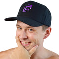 A smiling man wearing a black push pass whip baseball cap with a purple geometric whip logo on the front, photographed against a white background.